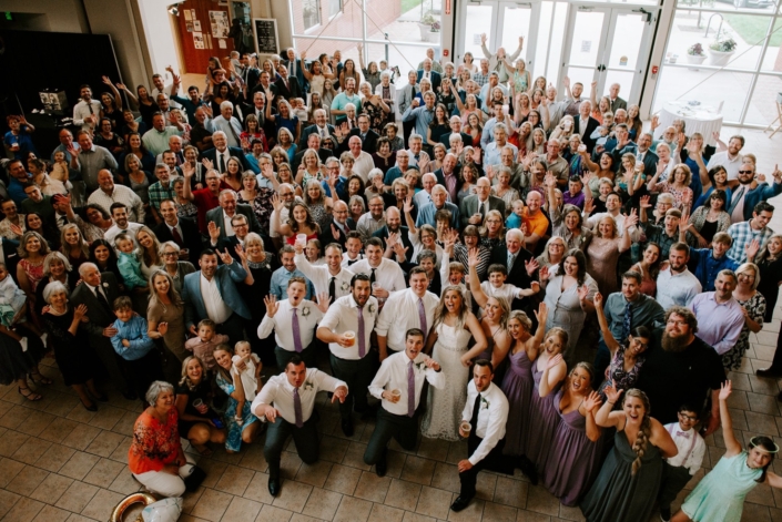 Large wedding group photo taken inside the FACC atrium.