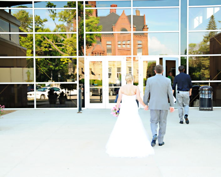 Bride and groom walking toward the Fairfield Arts & Convention Center entrance.