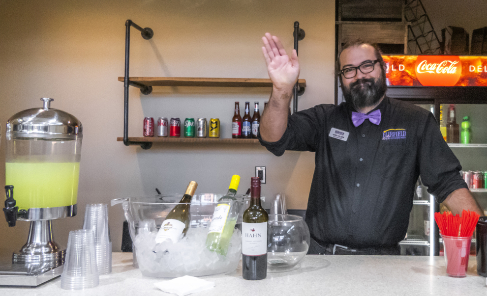 FACC wedding bartender serving guests at the Atrium bar with beer, wine, and beverage service displayed on ice.
